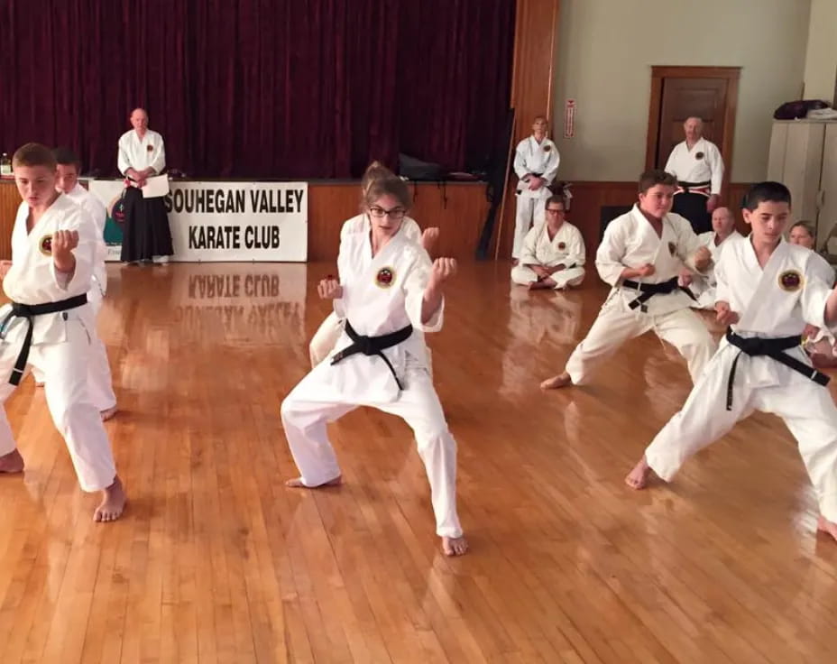 a group of people in karate uniforms