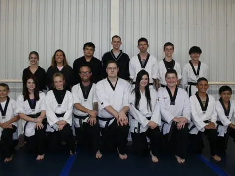 a group of people wearing white shirts and black suspenders