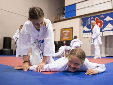 a person helping a child on the floor