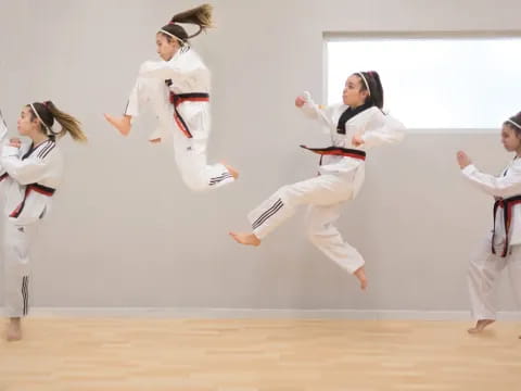 a group of women in karate uniforms