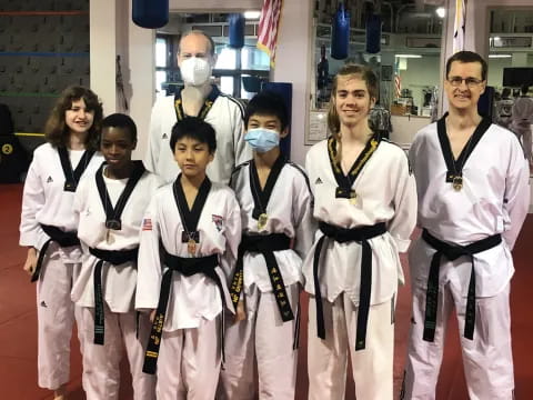 a group of people in karate uniforms