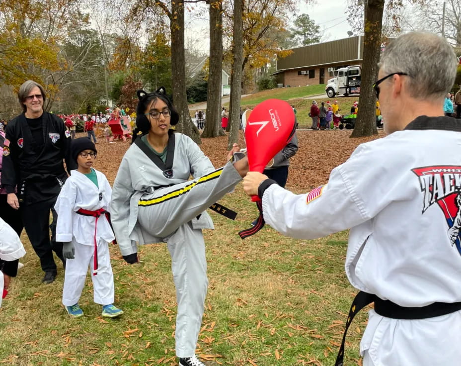 a man holding a red object in front of a group of people