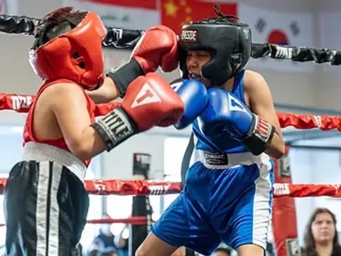 a person punching another man in a boxing ring