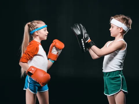 two women wearing boxing gloves