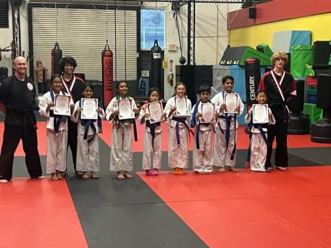 a group of children in karate uniforms