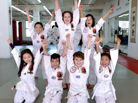 a group of kids wearing white uniforms