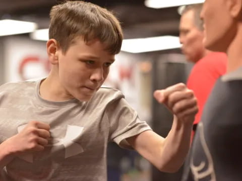 a boy holding a piece of paper