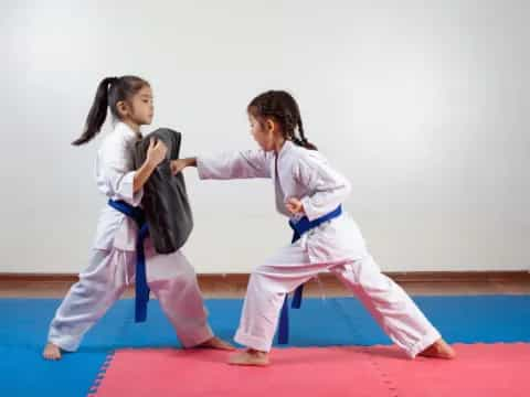 a couple of girls practicing karate