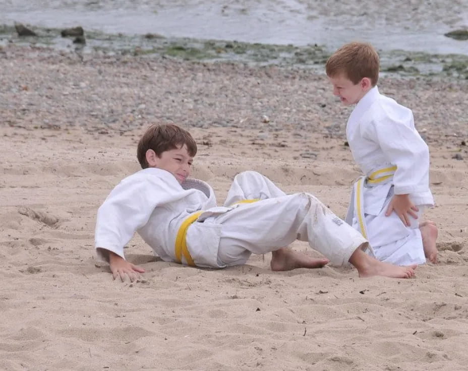 two boys playing in the sand