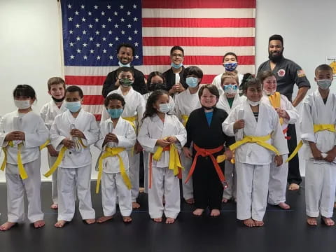 a group of people in white karate uniforms