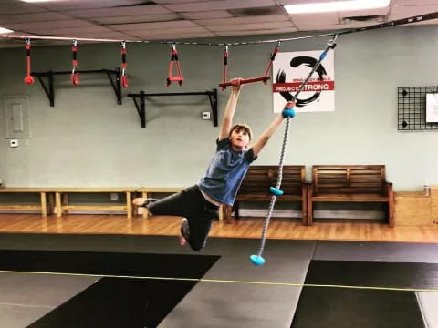 a person holding a pole in a gym