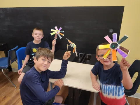 a group of boys wearing party hats