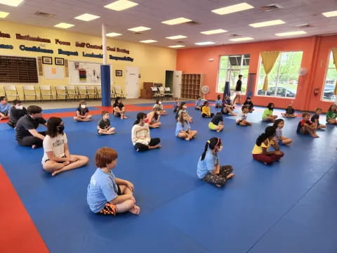 a group of people sitting on the floor in a room