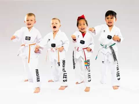 a group of kids in karate uniforms