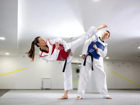 a man and woman in karate uniforms