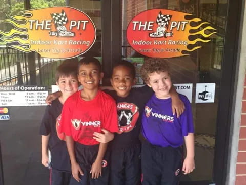 a group of boys standing in front of a store door
