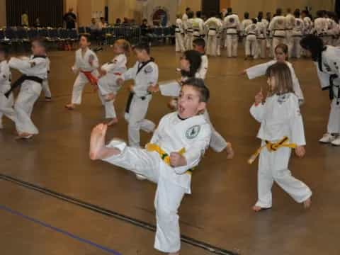 a group of children in karate uniforms