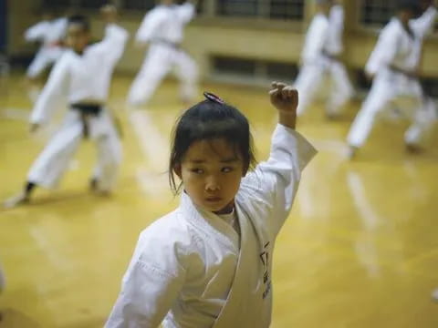 a group of people in karate uniforms