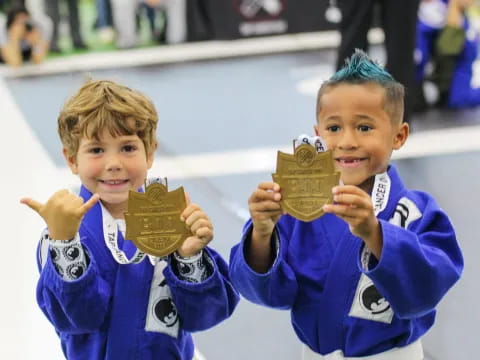 a couple of boys holding gold bars