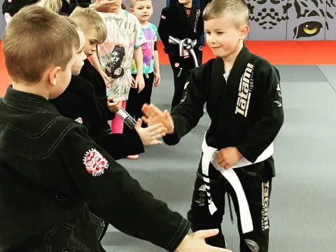 a group of boys in black karate uniforms