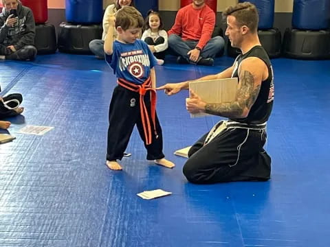 a person and a boy in a karate uniform