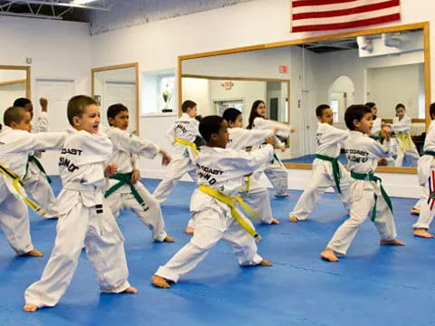 a group of children in karate uniforms