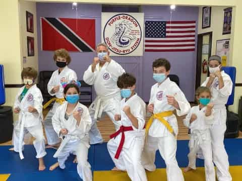 a group of kids in karate uniforms