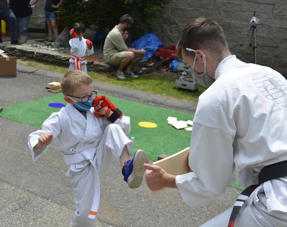 a person and a boy in white karate uniforms
