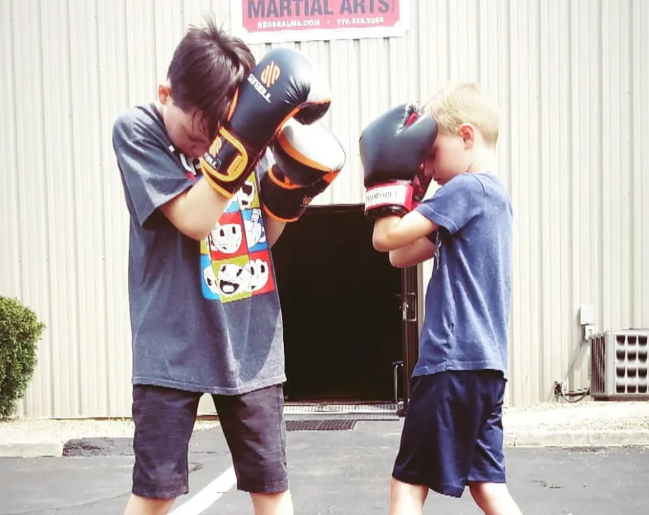 a couple of kids wearing boxing gloves