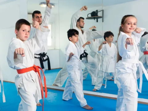 a group of people in karate uniforms