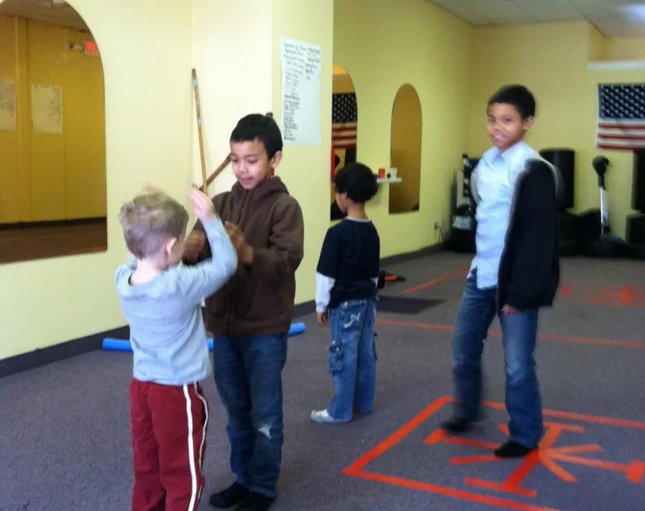 a group of kids playing in a hallway
