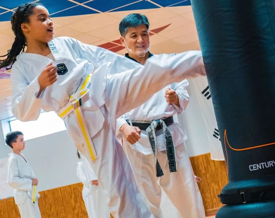 a man and woman in karate uniforms