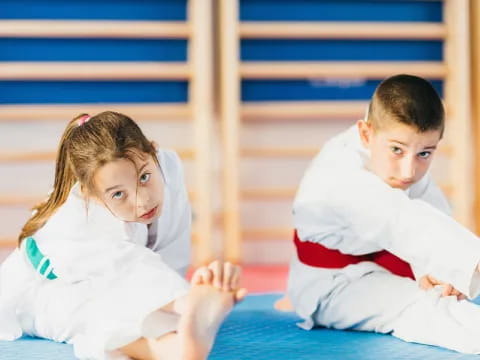 a boy and girl sitting on the floor