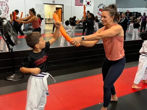 a person and a boy practicing martial arts