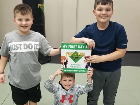 a group of boys holding a box