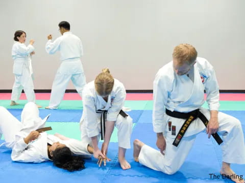 a group of people in white karate uniforms