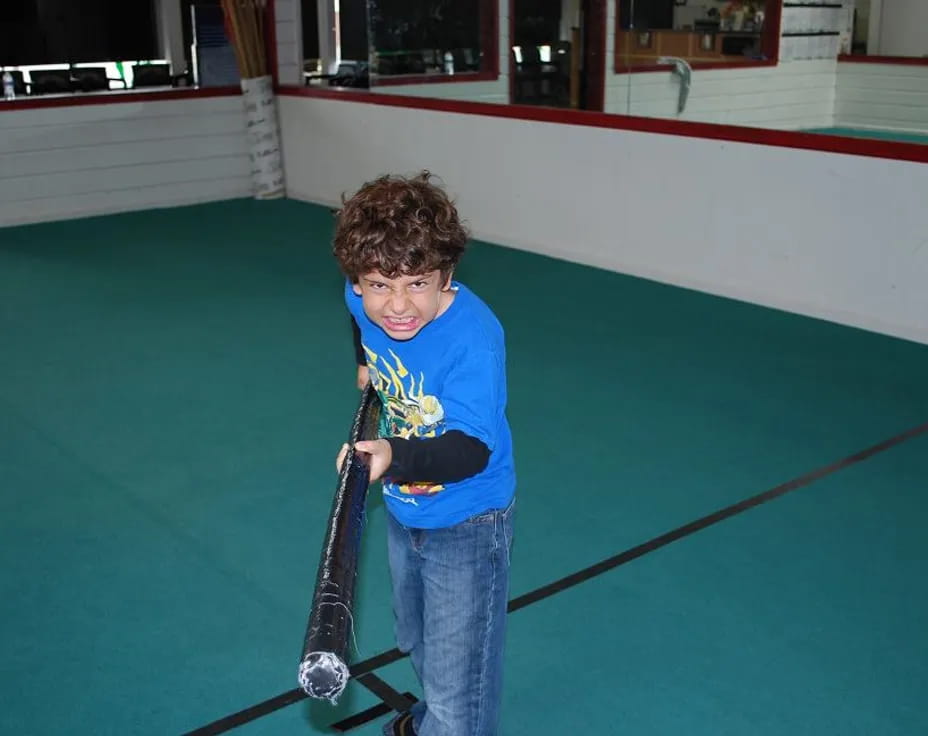 a boy holding a golf club