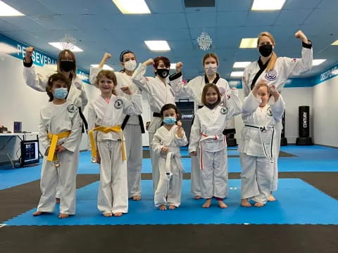 a group of people wearing white karate uniforms