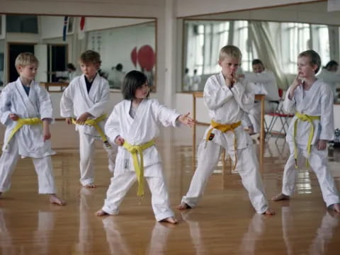 a group of children in karate uniforms