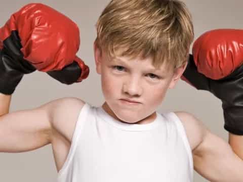 a boy wearing boxing gloves