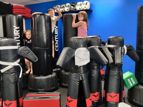 a group of people in a room with large tires