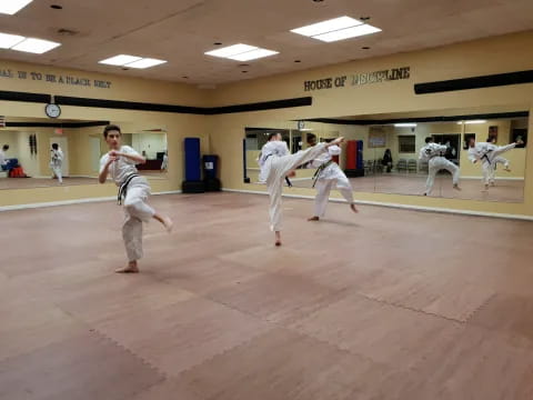 a group of people in karate uniforms