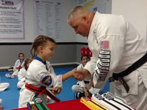 a man and a girl in karate uniforms