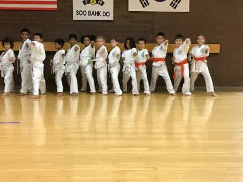 a group of people in white karate uniforms