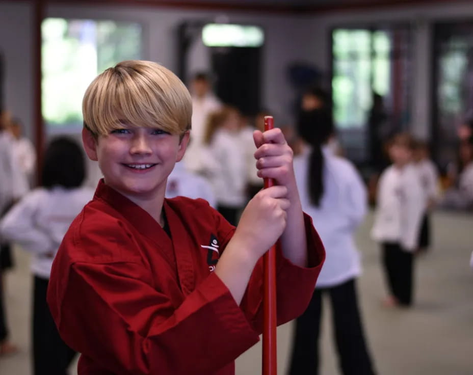 a boy holding a stick