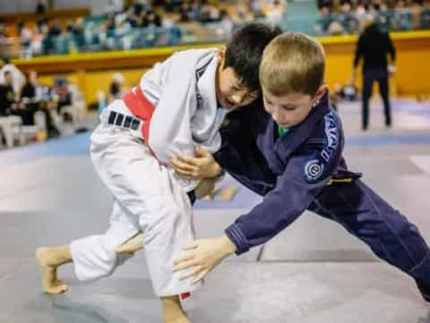 a couple of boys in karate uniforms