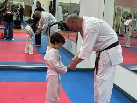 a man and a child in karate uniforms