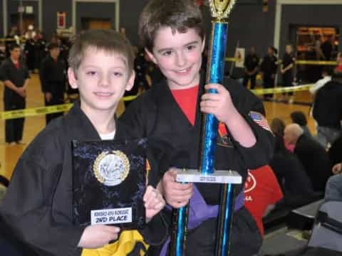 a couple of boys holding medals