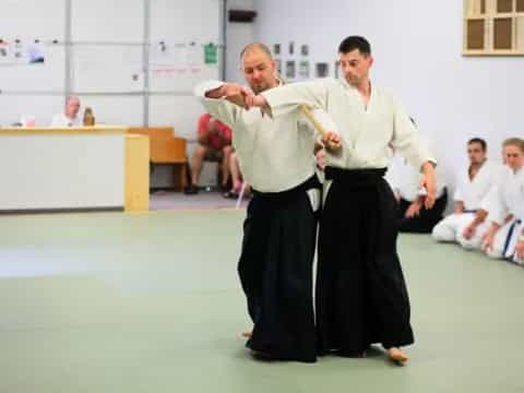 a person in a white robe and a person in a black robe