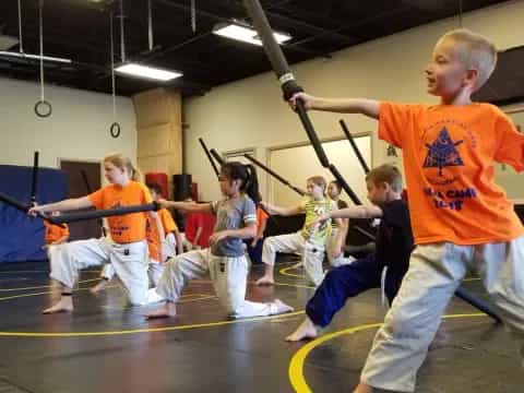 a group of kids practicing martial arts